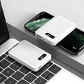 Black and white portable power bank with multiple USB ports showing front and side views.