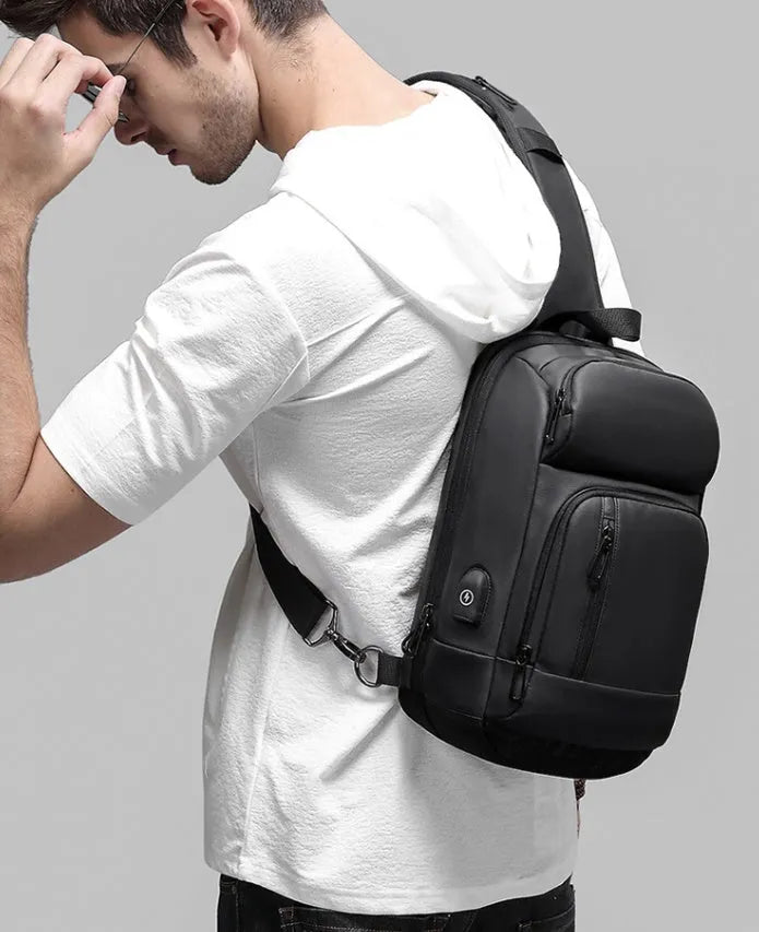 Black medium outdoor shoulder bag with square shape and air cushion strap