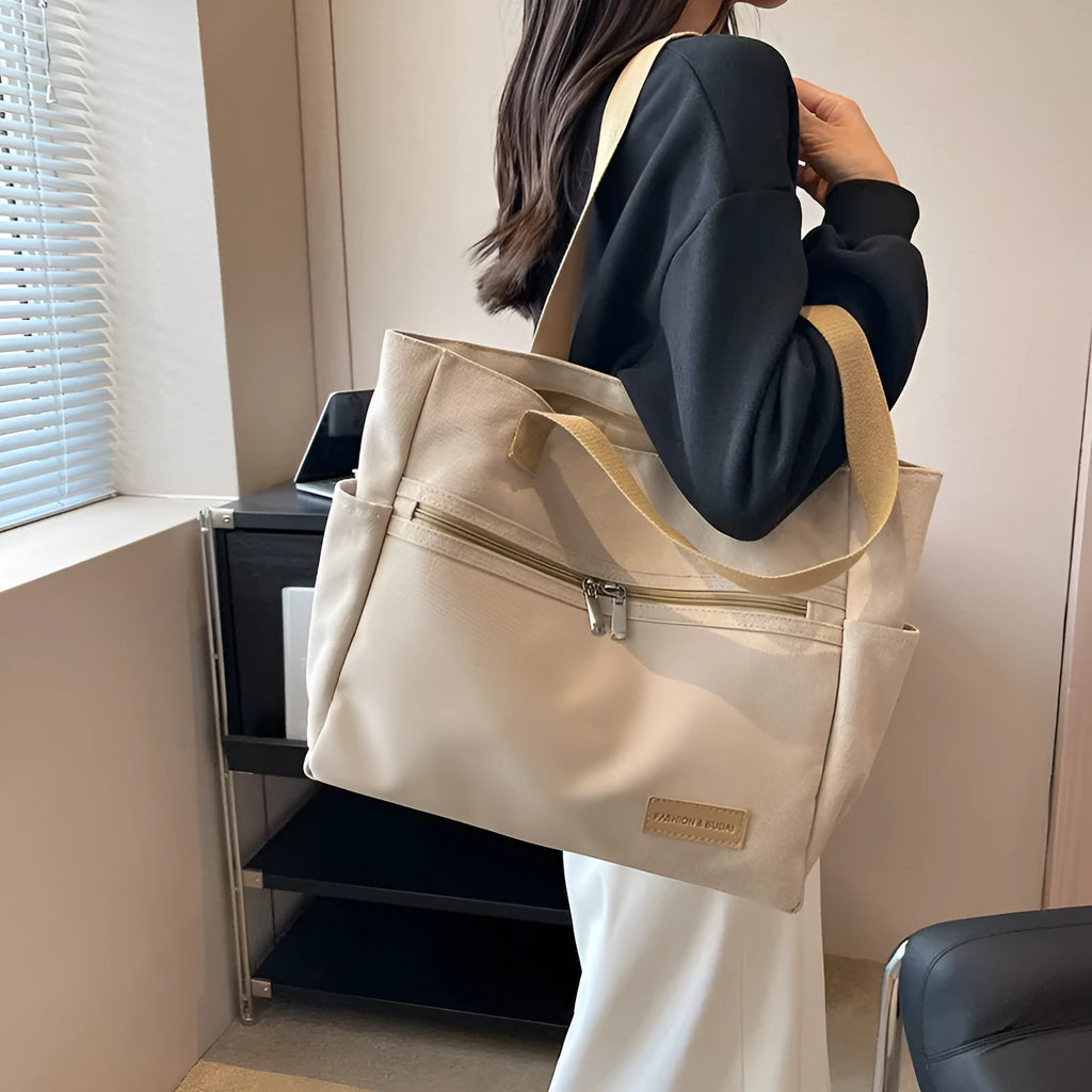 Canvas shoulder bag for women in khaki with stitching detail, open front pocket, and double shoulder straps