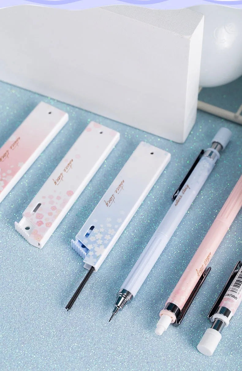 Cartoon design automatic pencil set with three 0.5mm pencils and HB refill boxes on a white background.