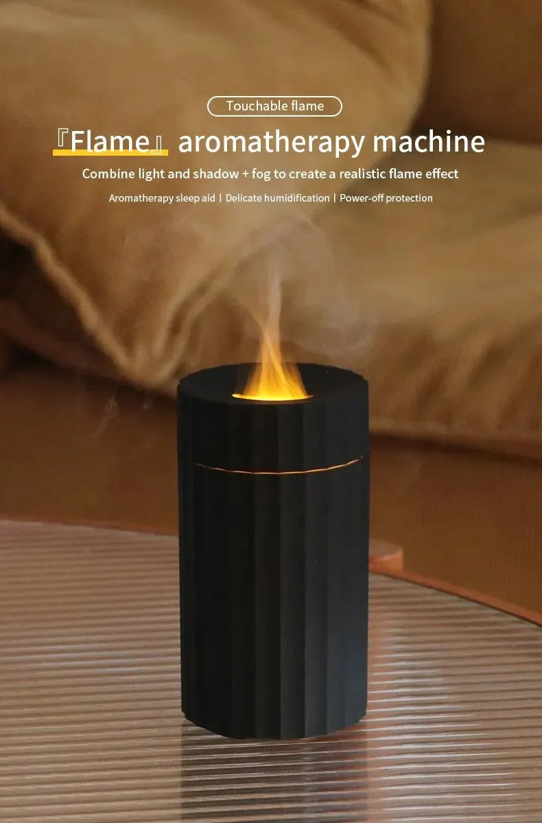 Black and white essential oil diffuser and humidifier with a simulated LED flame effect on a table.