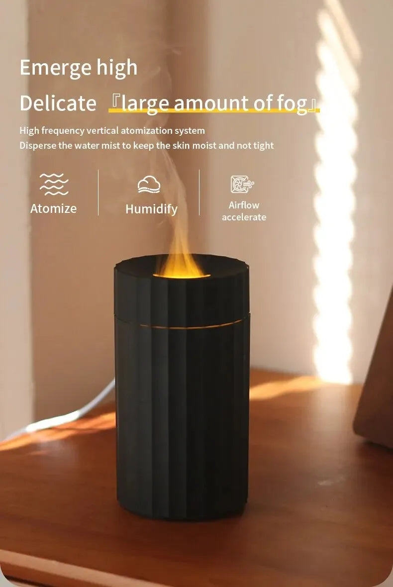 Black and white essential oil diffuser and humidifier with a simulated LED flame effect on a table.