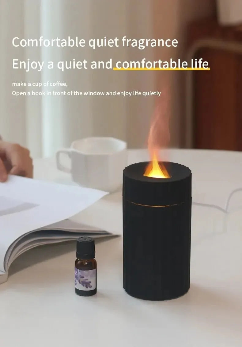 Black and white essential oil diffuser and humidifier with a simulated LED flame effect on a table.
