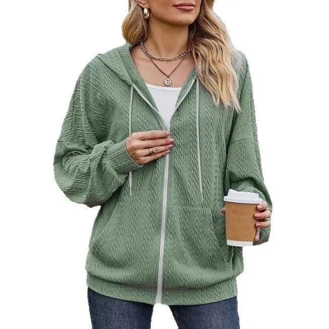 Green women's hooded zipper coat with a loose fit on a hanger.