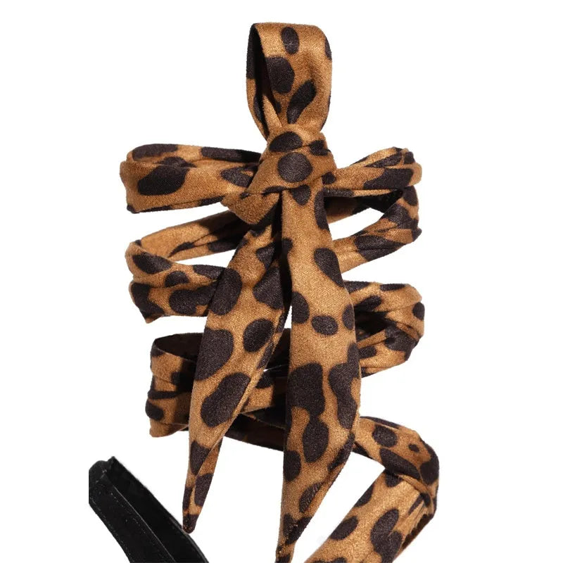 Light brown leopard print women's strappy high heel sandals with stiletto heel and cross-strap design