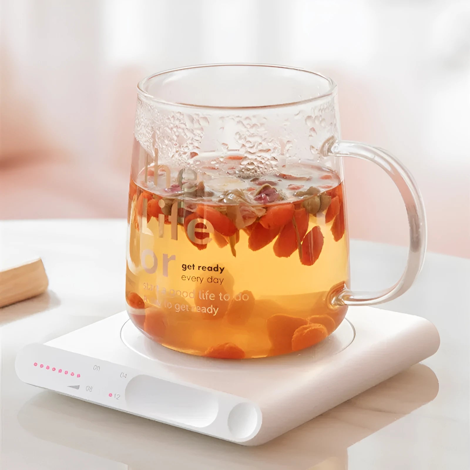 USB-powered heating cup pad in pink or white with mechanical controls