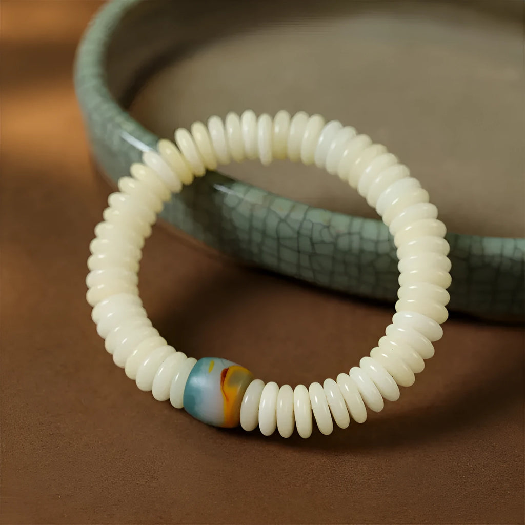 White Bodhi seed Tibetan bracelet showing 3x10mm dimensions in bracelet and handheld styles