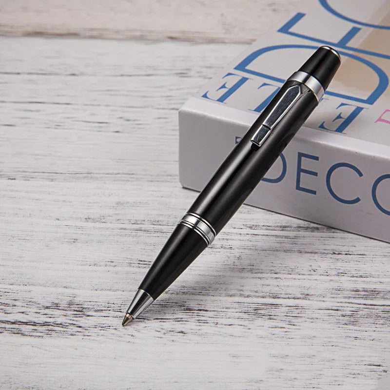 Short black metal ballpoint pen with rotating mechanism, showing bullet tip and compact dimensions