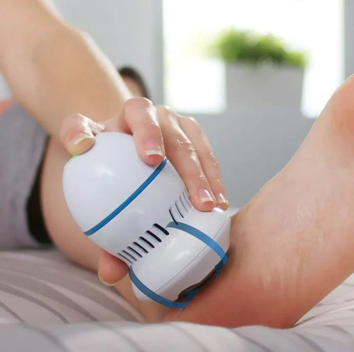 Beige and white electric foot file machine with grinding head, USB cable, two spare heads, brush, and sponge ring.