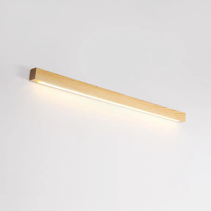 Walnut-coloured wooden log strip LED wall lamp with acrylic diffuser in minimalist design.