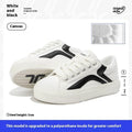 Women's low-top board shoes in a black and white colour combination, showing round toe and front lace-up design.