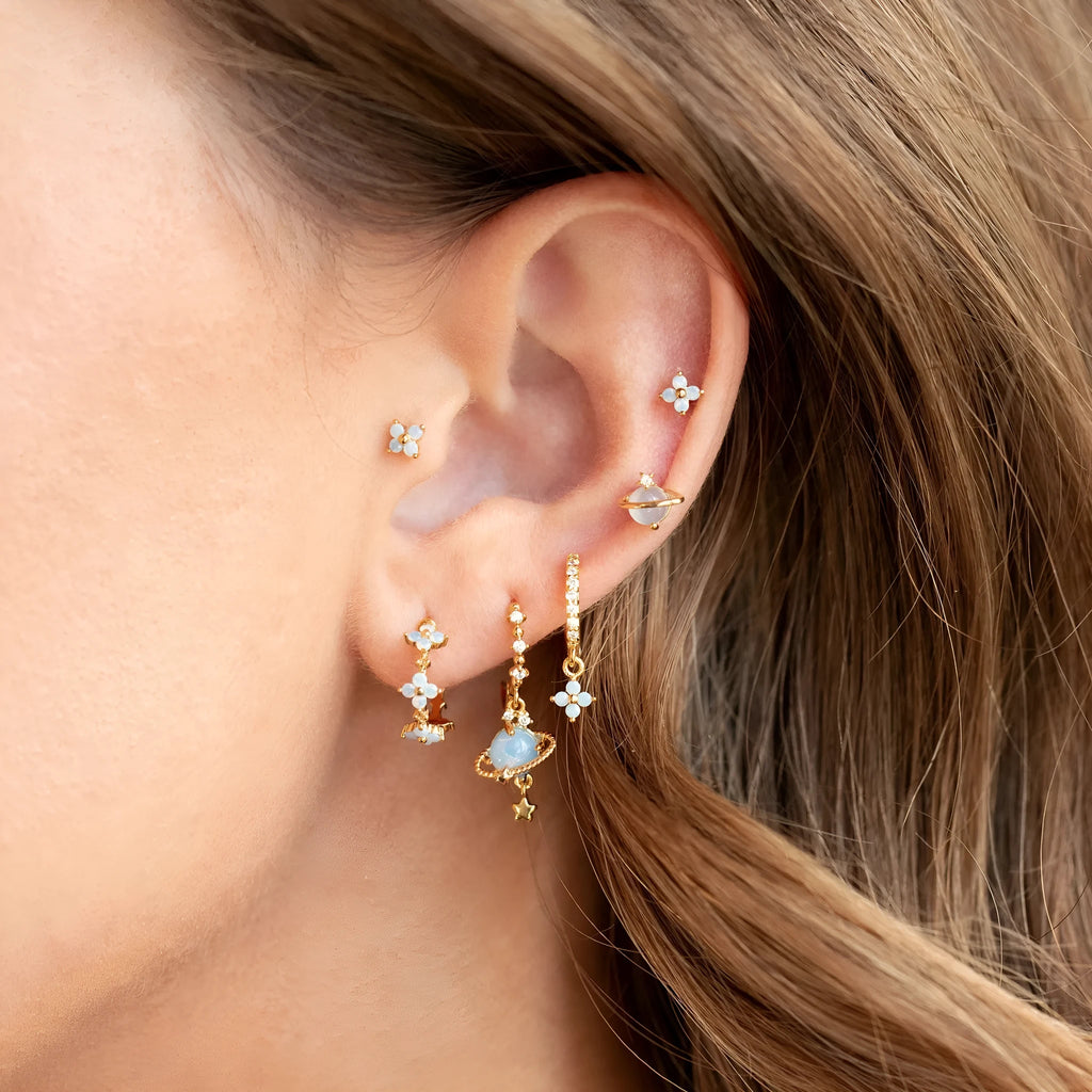 Gold and silver Japanese Korean style stud earrings with blue flower nail shape and zircon mosaic detail.