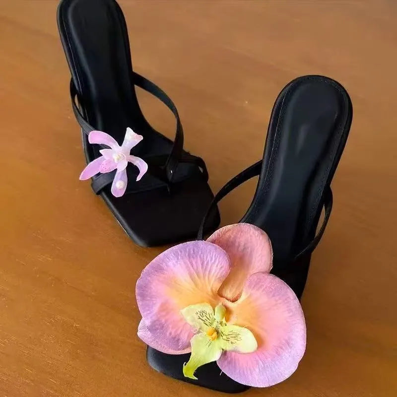 Women's handmade asymmetric flower design sandals in calf leather with a high heel and square toe.