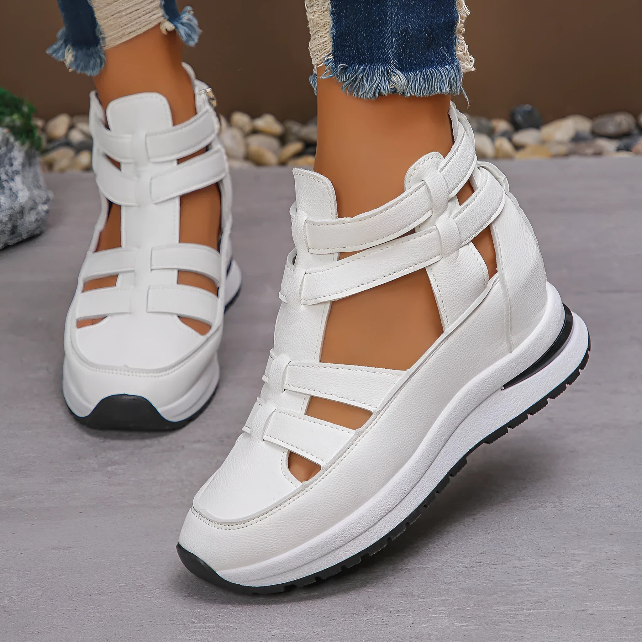 Black women's close-toed platform sandals with hollow-out design and Velcro strap on a white background.