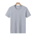 Men's and women's loose-fit cotton T-shirt in solid colours like navy blue, red, and white, shown as a short-sleeve pullover top.