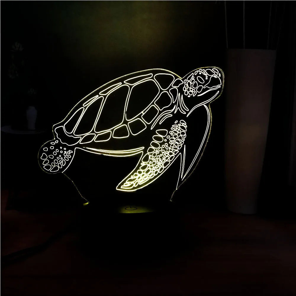 A glowing 3D acrylic turtle-shaped LED night light on a surface, showing its detailed sculpture and soft coloured light.