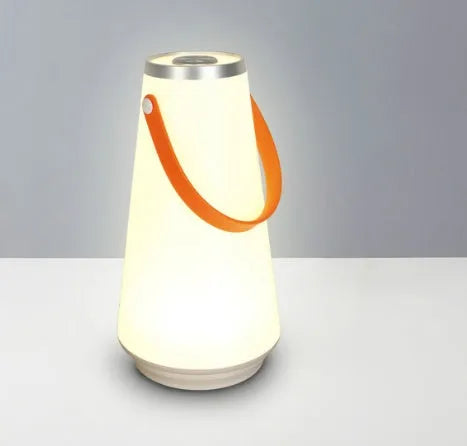 White USB rechargeable LED bedside night light with touch control on a wooden table.