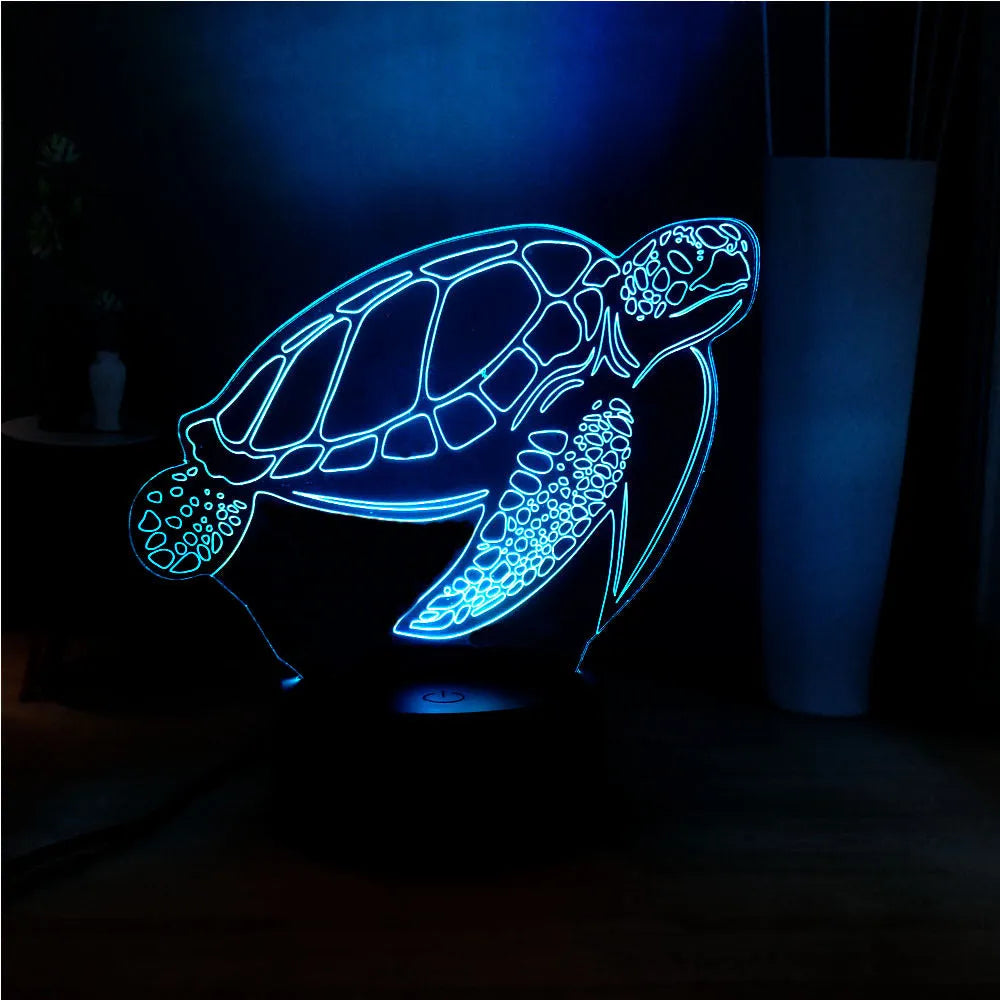A glowing 3D acrylic turtle-shaped LED night light on a surface, showing its detailed sculpture and soft coloured light.