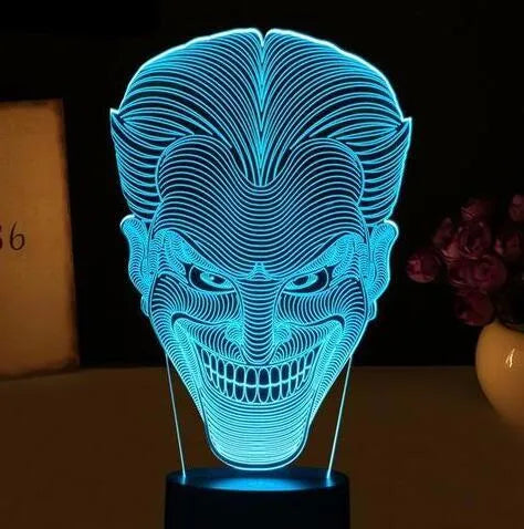 USB-powered 3D acrylic LED table lamp with remote control on a desk, displaying colourful gradient lighting.