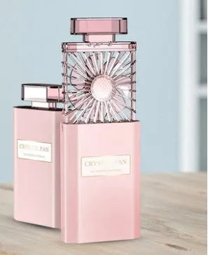 Pink portable rechargeable perfume fan with essential oil diffuser and USB charging port.