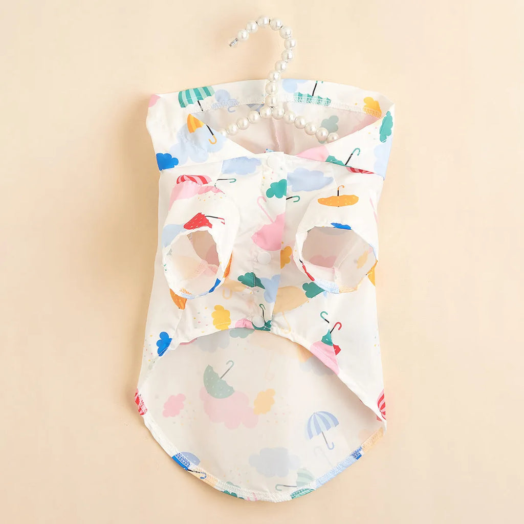 Colourful cartoon umbrella pattern polyester dog raincoat laid flat showing full design