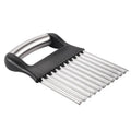 A black stainless steel potato wave knife on a kitchen counter, showing its corrugated blade.
