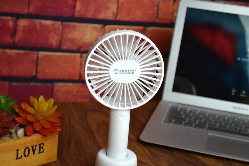 White ORICO FH1 portable USB rechargeable handheld desk fan with three-speed settings.