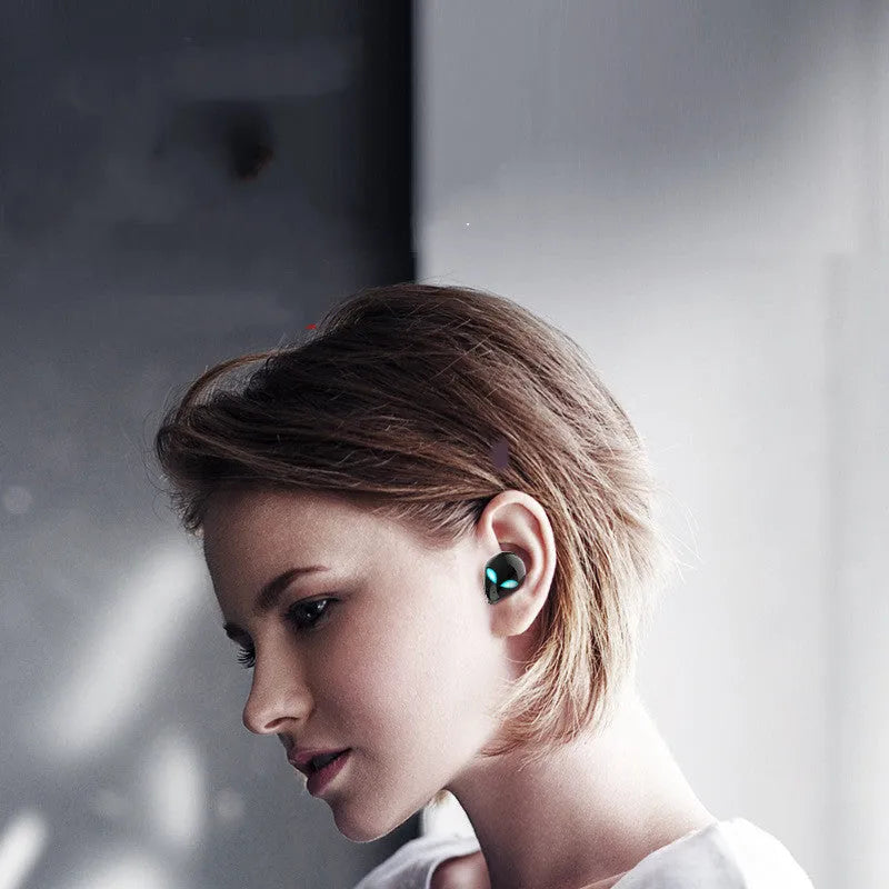 Creative Outer T8 Starman alien-design wireless Bluetooth earbuds in red or blue with a charging case.