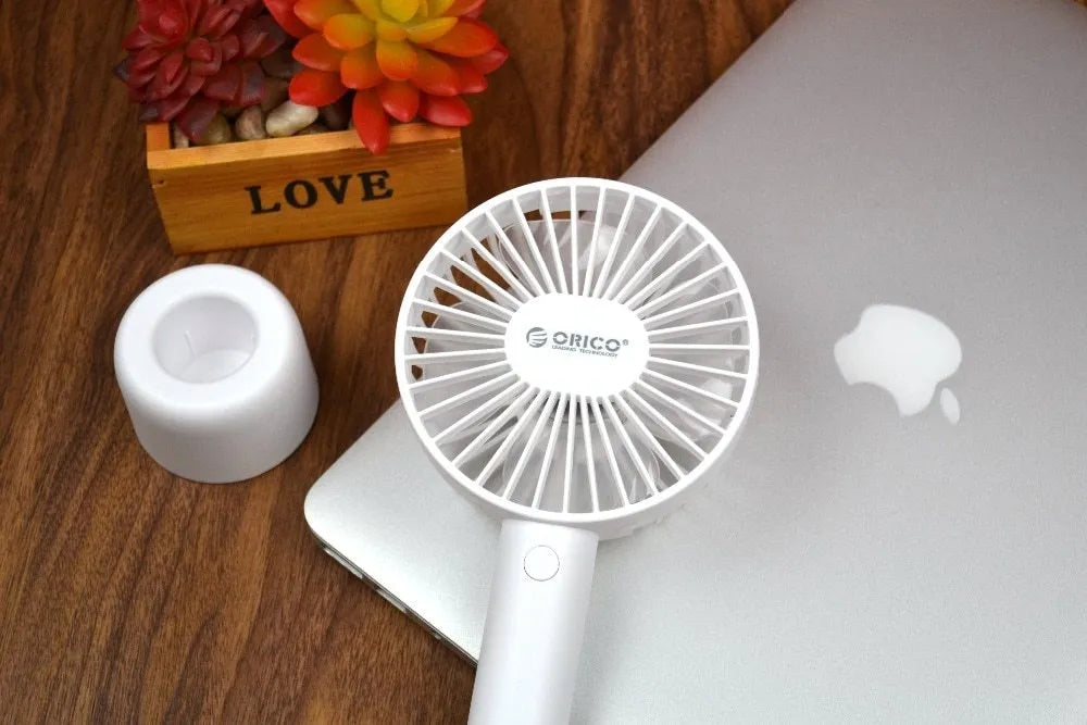 White ORICO FH1 portable USB rechargeable handheld desk fan with three-speed settings.