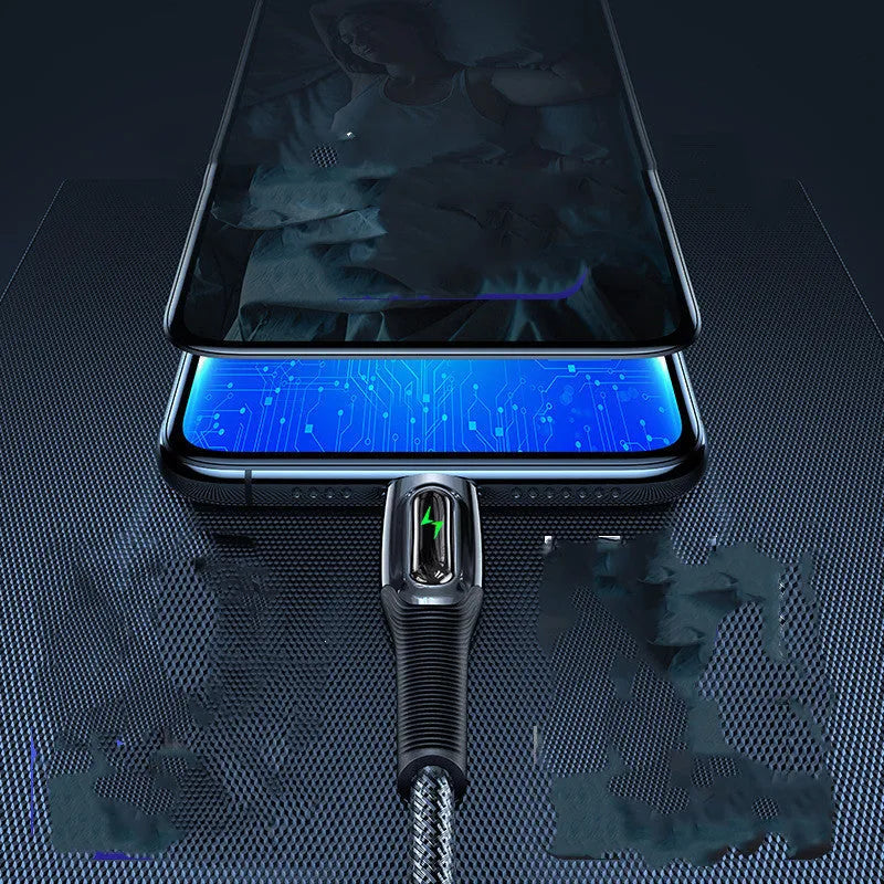 Black braided lightning data cable with zinc alloy connector next to an iPhone 12.