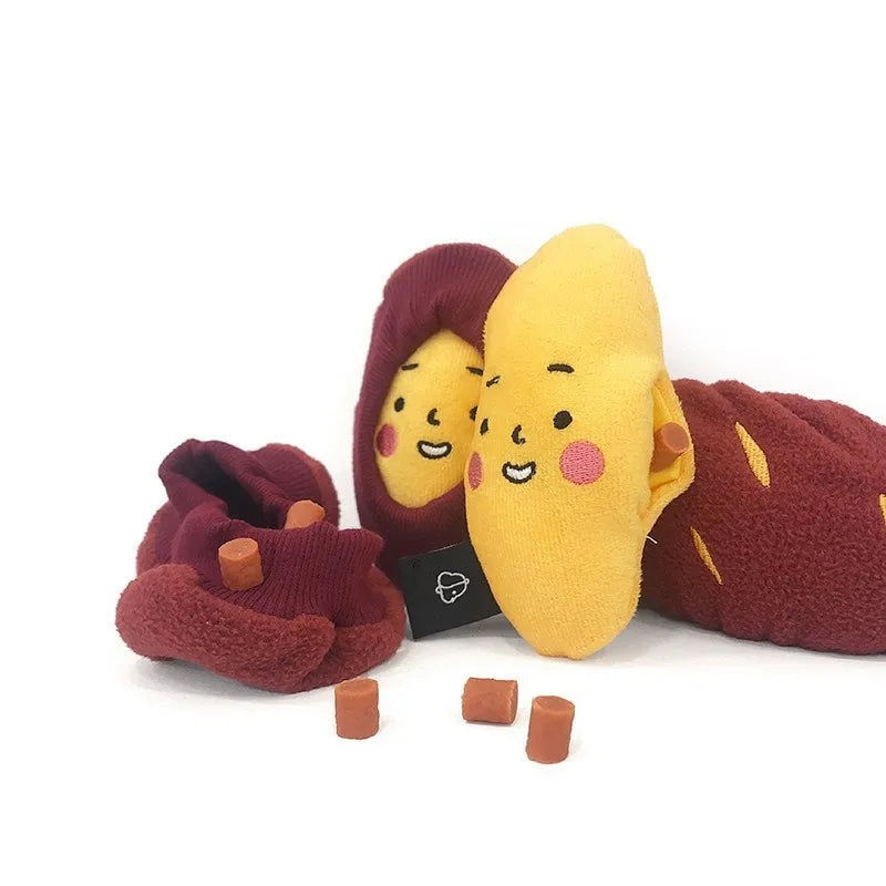 Red fabric pet toy shaped like sweet potato with internal hidden treat pockets for dogs