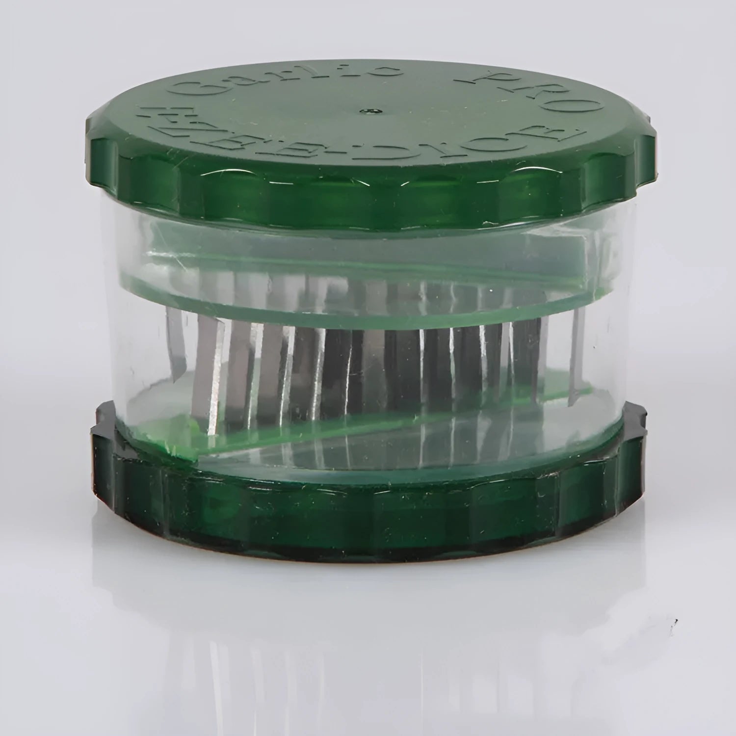 Green transparent PP plastic garlic peeler kitchen gadget on a countertop