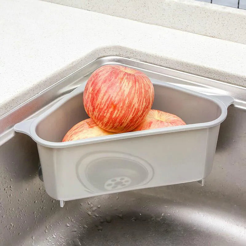 Beige and blue plastic triangle sink storage rack with suction cups holding a sponge