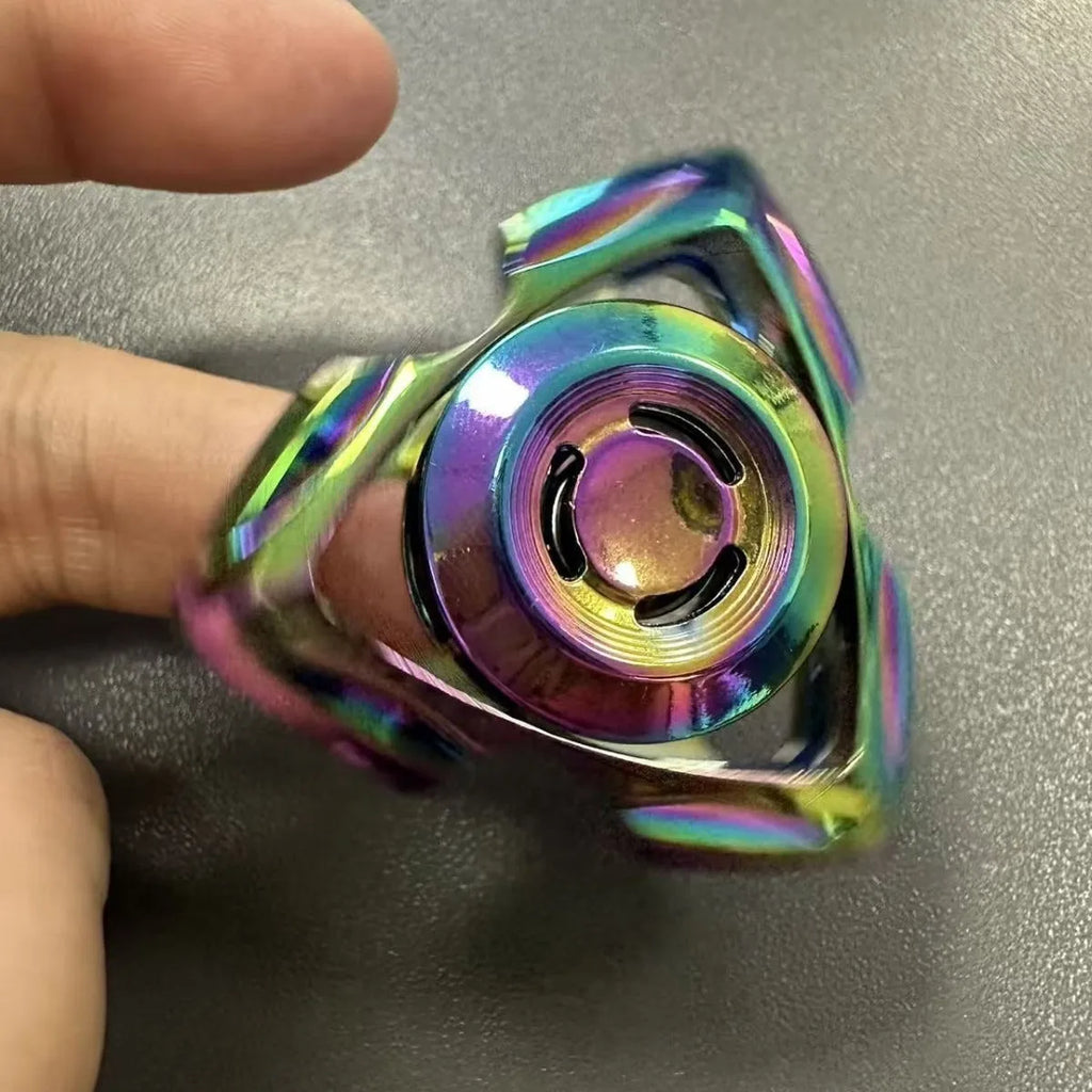 A silver alloy fingertip gyro decompression toy with a central spinning bearing.