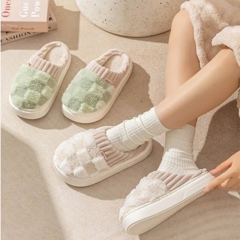 Plaid pattern women's slippers with plush lining and a light-coloured non-slip PVC sole, shown in a grey colour option.