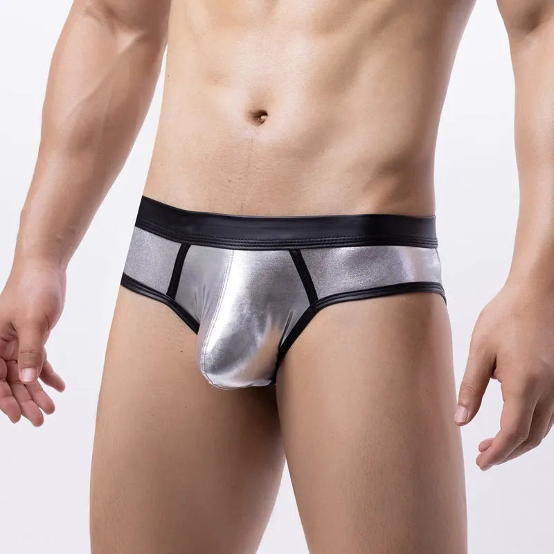 Gold metallic men's swim briefs with low waist and body-shaping design on a mannequin.