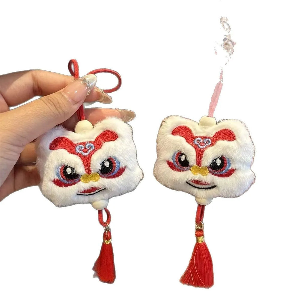 Blue and yellow handmade plush lion keychains with star stone decoration on a cartoon style tassel ornament.