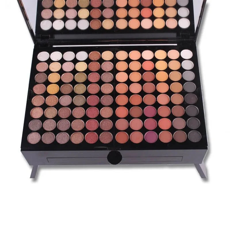Piano-shaped makeup palette open to show 180 eyeshadow colours with powder and blush pans