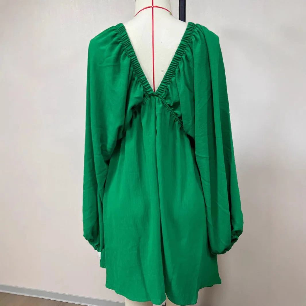 Women's apricot V-neck midi dress with long puff sleeves and a flounced skirt.