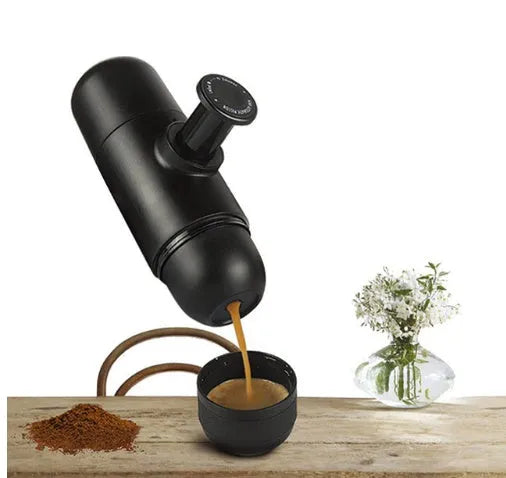 Black portable manual coffee machine showing compact 6cm design with pressure system for travel brewing