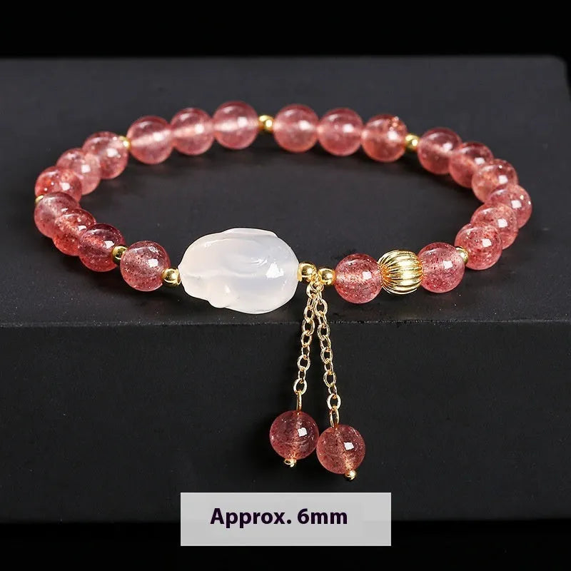 Natural strawberry quartz and agate bracelet for women with 6mm round beads and a white rabbit charm.