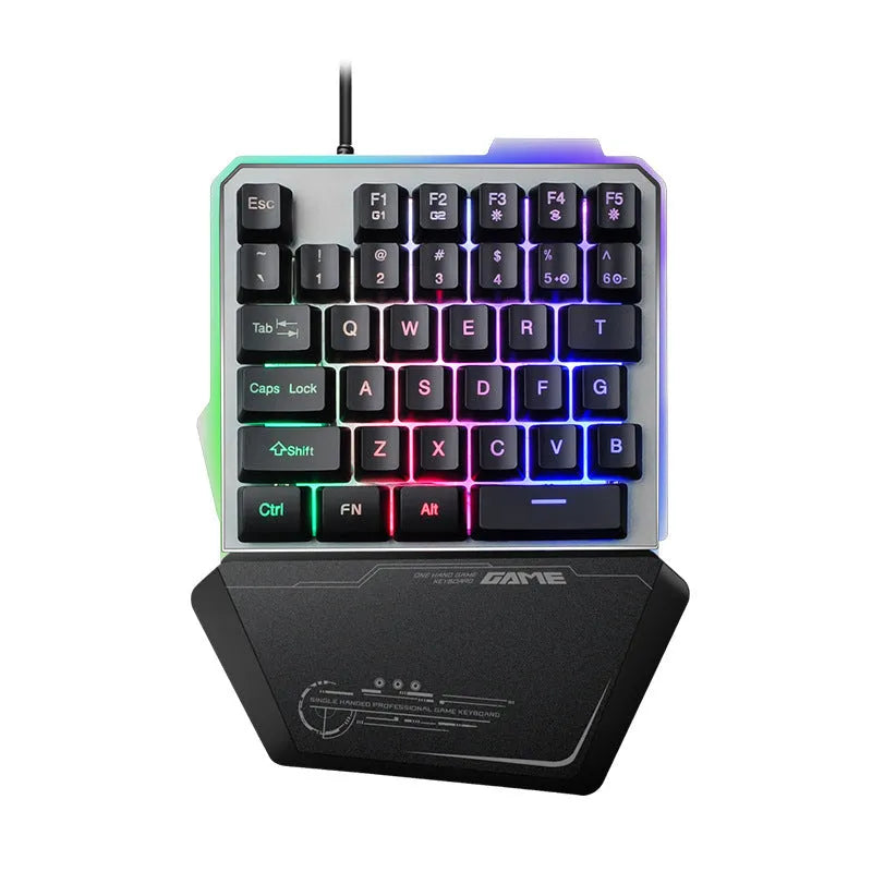 Black one-handed mechanical gaming keyboard with RGB backlit keys on a desk.
