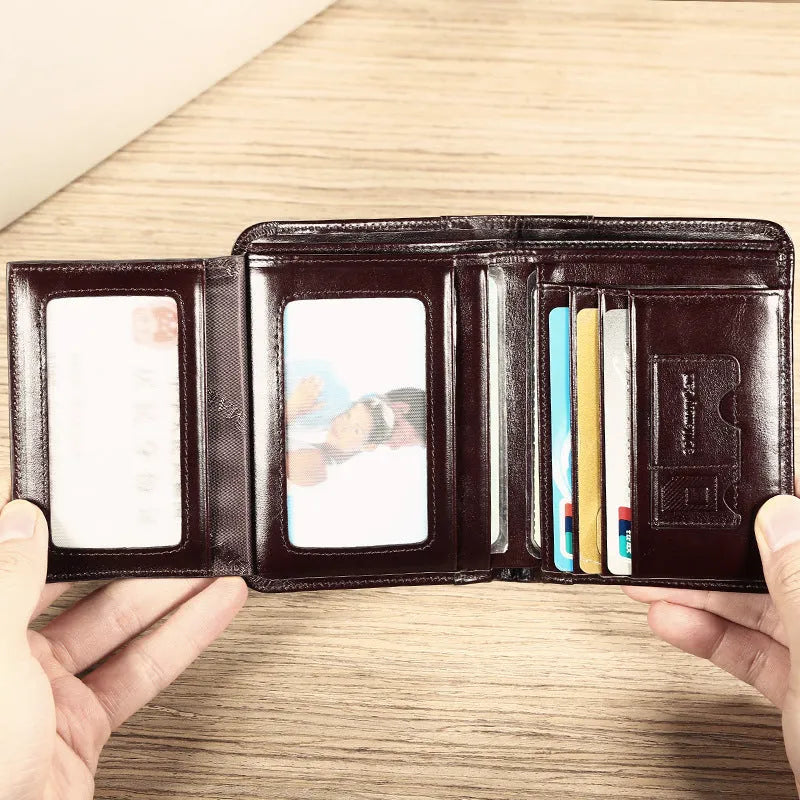 Men's brown leather bifold wallet open to show card slots, coin pocket, and banknote compartment.