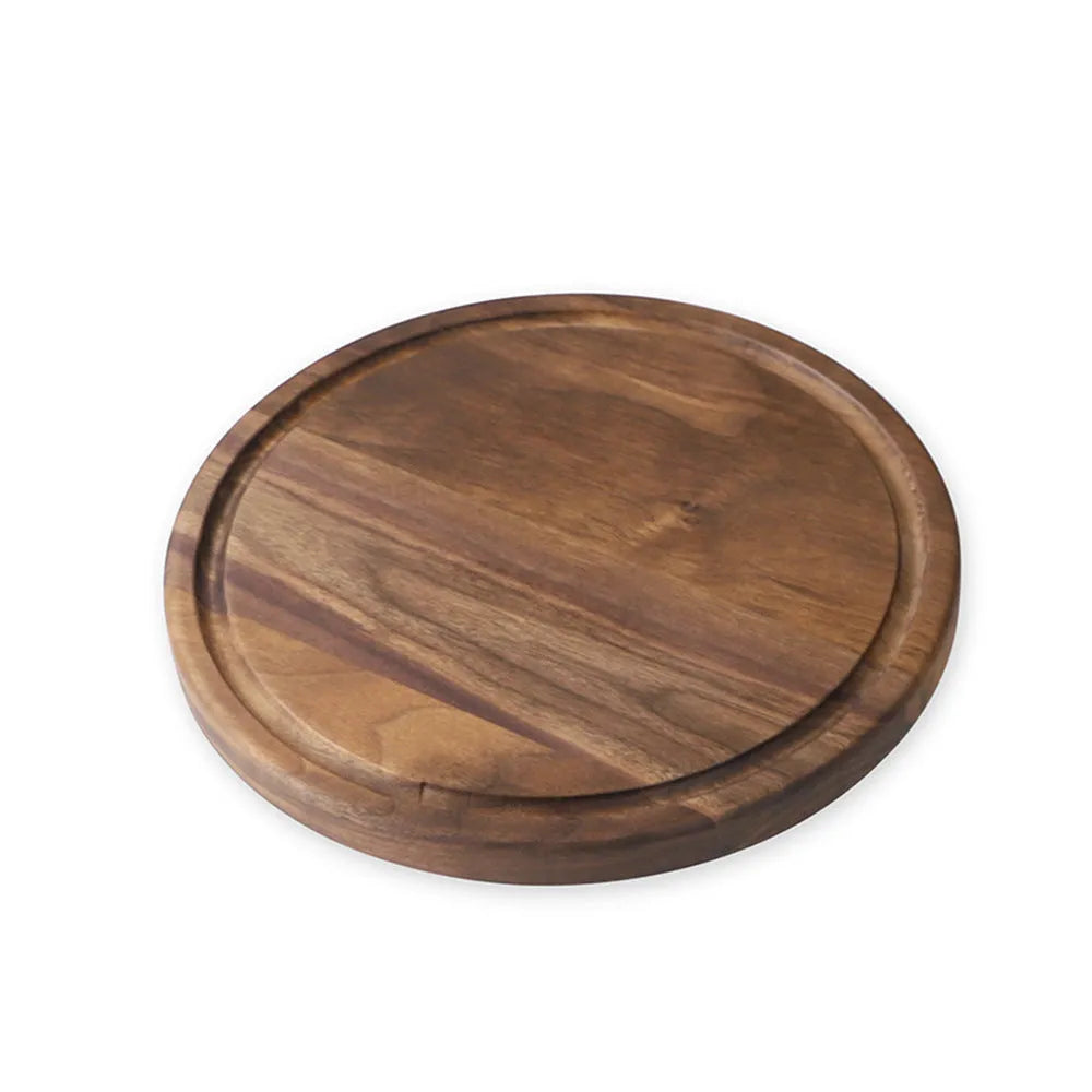 Solid black walnut wood chopping board with a deep perimeter groove and a side handle, shown as a serving tray.