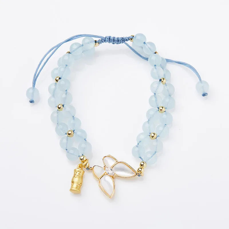 Women's aquamarine woven bracelet with butterfly design and 6mm stone beads
