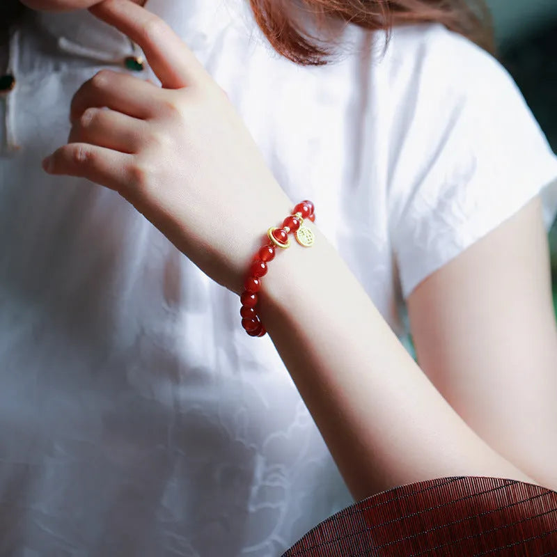 Natural red agate bracelet with hand-woven cord in national style, shown with blessing card.