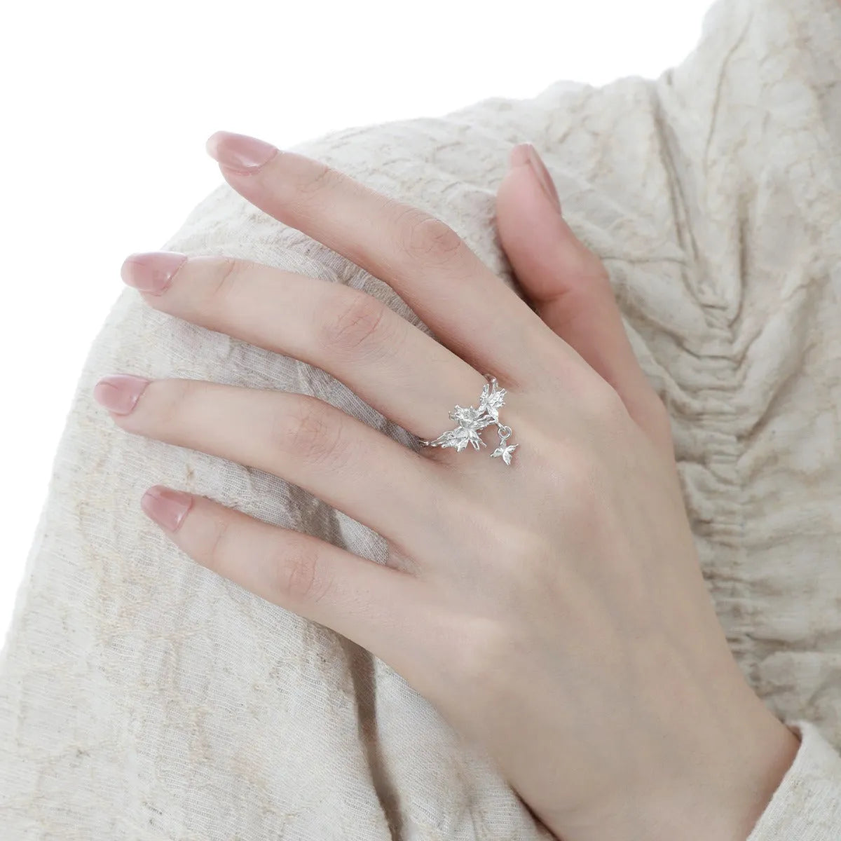 Silver butterfly ring with adjustable opening in white gold or gold finish.