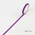 Close-up of narrow 5mm solid colour paper tape rolls in crimson and deep purple.