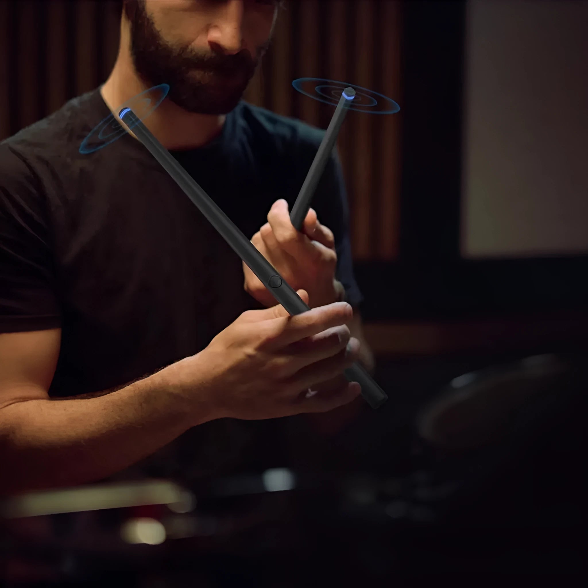 Black somatosensory air drum kit with wireless connectivity and LED lighting displayed with drumsticks
