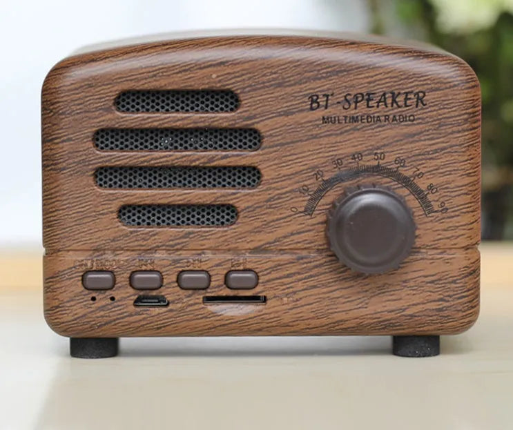 Compact portable Bluetooth speaker with a vintage wood grain finish on a plastic shell